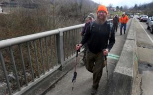 Great Eastern Trail through-hikers Bart Houck and Joanna Swanson cross the Tug Fork River and enter West Virginia, the approximate halfway point on their 1,800-mile, nine-state trek. Accompanying them are TuGuNu Hiking Club members Tim McGraw and Paul Kenney. 